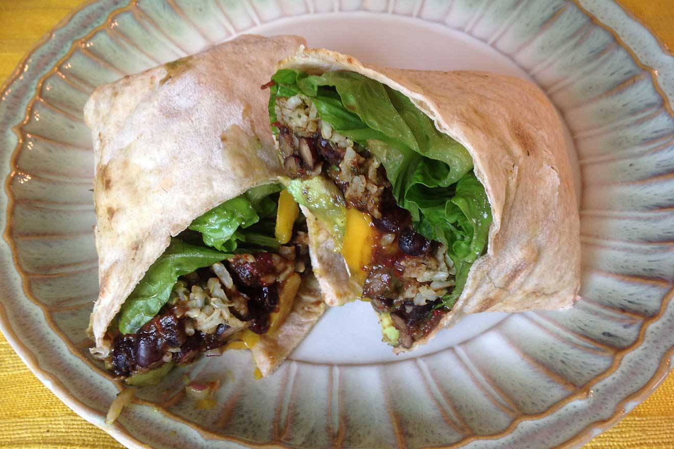 spicy black bean burrito with lime-cilantro rice and mango